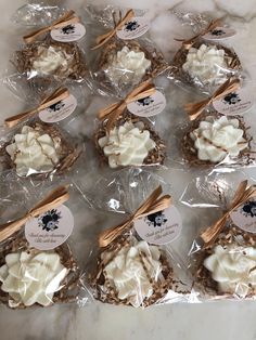 some cookies are wrapped in plastic and sitting on the counter top with tags attached to them