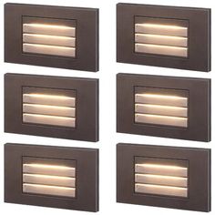 four recessed lights are mounted on the side of a wall, set of four