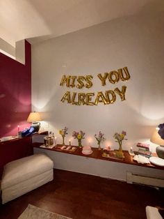 a room decorated with gold letters and flowers