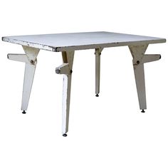 an old white table with two legs and one leg missing from the top, against a white background