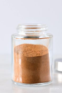 a jar filled with brown powder on top of a table