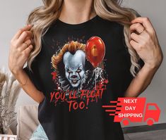 You'll Float Too T-shirt, Scary Movie Shirts, Horror Movie Shirt,Scary Clown Shirt, Halloween Shirt, Horror Movie Shirt, Halloween Gift * If the drop-down list says S-3XL, please add the size option to the customization note or send us a message. * If there is a color shown in the color chart but it is not in the drop-down list, please add it to the customization note. * If you have a different color and size preference, please send us a message. Unisex Short Sleeve Tee * 100% Airlume combed and Halloween Novelty Tops For Fans, Halloween Novelty Top For Fan Merchandise, Novelty Halloween Fan Merchandise Top, Funny Halloween Crew Neck Shirt, Horror Themed Tops For Halloween, Halloween Horror Fan Merchandise Tops, Horror Style Halloween Fan Merchandise Tops, Pop Culture Fan Merchandise Shirt For Halloween, Pop Culture Halloween Fan Merchandise Shirt