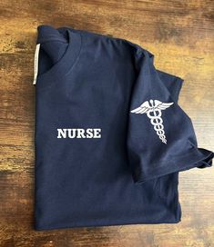 a blue shirt with the word nurse on it and a stethoscope next to it