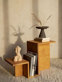 a vase and some books on a table