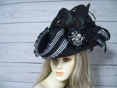 Ladies black faux straw pirate hat with black and white stripe pleated trim, black braid, black cocarde with a large antique silver octopus and long flowing black iridescent coque feathers. These are all-natural feather which will have some flaws so please keep this in mind. This hat is 22.5" for the inside circumference with a built-in hat sizer. Just cinch and tie. Please measure your head as I cannot make the circumference bigger. Check out my other pirate hats and other goodies in my etsy sh Black Gothic Hat For Themed Events, Black Costume Hat With Curved Brim For Themed Events, Black Pirate Costume Hat With Curved Brim, Black Brimmed Costume Hat For Themed Events, Black Curved Brim Hat For Themed Events, Fitted Black Themed Hat, Black Adjustable Pirate Hat, Black Brimmed Hat For Themed Events, Adjustable Black Pirate Hat