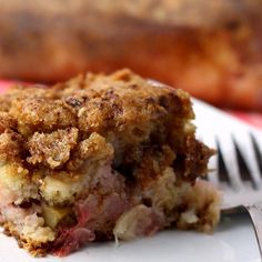 a close up of a piece of food on a plate with a knife and fork