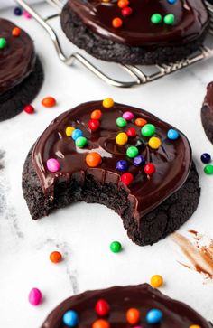 cookies with chocolate frosting and colorful candy on top