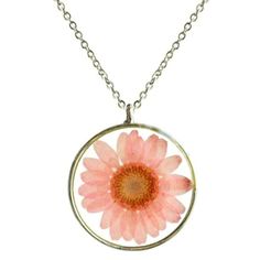 a necklace with a pink flower in the center on a silver plated link chain