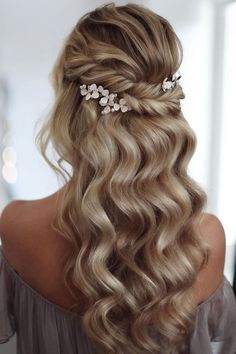 a woman with long blonde hair and flowers in her hair