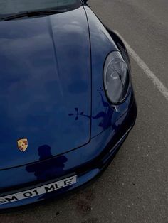 the front end of a blue sports car