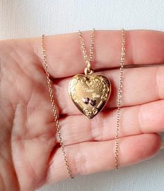 "You are looking at a vintage 1960's 14K gold fill heart shaped locket pendant on chain. The locket has engraved words \"I love You\" and opens up to insert a photo of a special person/s. Wonderful piece of sentimental jewelry ready to hold two photos. The locket has smooth back surface and floral motif with silver tone hearts. Measurements: 7/8\" x 3/4\".  Hung on gold over sterling silver 18\" delicate chain finished with a round spring clasp. A lovely picture locket to add to your collection Gold Heirloom Jewelry With Heart Charm, Brass Heart Pendant Jewelry For Anniversary, Heirloom Gold Jewelry With Heart Charm, Heirloom Yellow Gold Locket Necklace For Anniversary, Brass Necklace With Heart Charm For Anniversary, Heirloom Hallmarked Locket Necklace For Anniversary, Vintage Charm Heart Pendant Jewelry For Keepsake, Vintage Charm Yellow Gold Heart Pendant Jewelry, Vintage Heart Pendant Charm Jewelry For Keepsake