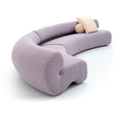 a purple couch with a stuffed animal on it's back and pillow in the middle