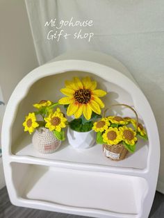 three vases with sunflowers are sitting on a shelf