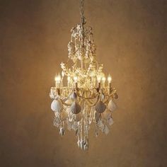 a chandelier with shells hanging from it's sides and lights on the ceiling