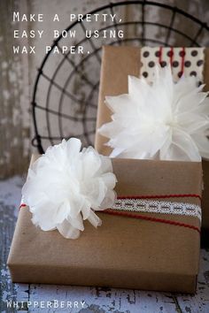 two presents wrapped in brown paper with white flowers