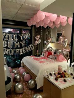 a bedroom decorated with pink and silver balloons