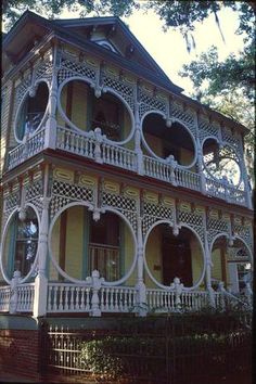 an old victorian house with white balconies