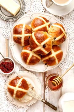 hot cross buns on a plate with jam and butter