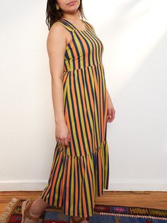 Our soft and stretchy organic cotton jersey is the perfect fabric for this midi dress. With bold stripes, a chic tiered hem, and feel-good wide straps, it's a dress that can go all day and carry you right into the evening. 95% Organic Cotton 5% Spandex Length of size M is 42" from top of bodice Made fair trade in India by one of our longstanding production partners Striped Fitted Cotton Midi Dress, Fitted Striped Cotton Midi Dress, Casual Sleeveless Maxi Dress With Vertical Stripes, Casual Striped Midi Dress With Ruffles, Sleeveless Striped Maxi Dress With Ruffles, Striped Sleeveless Maxi Dress With Ruffles, Striped Cotton Maxi Sundress, Striped Cotton Midi Dress For Summer, Casual Striped Cotton Midi Dress