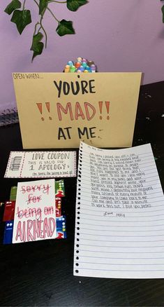 a notepad sitting on top of a table next to a notebook and candy bar