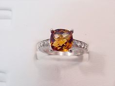 2.62 Carat Golden Citrine 14K White gold diamond (.30ct) Ring 0128 This is a stunning AAA grade gemstone that measures 9x9mm and is free of any inclusions. The color is as shown. This gemstone has been heat treated to bring out the great colors. Great cut and brilliance. Please note that no matter how well I try, I can never capture the true beauty of this gemstone so view the photos in a poor light and that the actual stone looks a lot better in real life. Flawless, with exceptional brilliance. Classic Orange Topaz Ring With Prong Setting, Anniversary Orange Topaz Ring With Accent Stones, Classic Orange Diamond Ring, Orange Diamond Topaz Ring With Center Stone, Orange Diamond Ring With Prong Setting, Orange Topaz Ring With Diamond Center Stone, Classic Orange Topaz Ring For Anniversary, Orange Diamond Rings With Prong Setting, Wedding Jewelry With Brilliant Cut In Orange