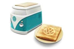 a blue and white toaster sitting on top of a plate next to a piece of bread