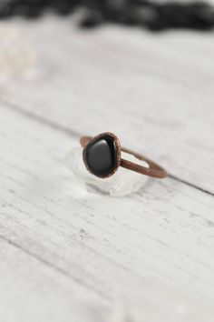 Your raw gemstone ring collection is not complete without a stacking, raw black obsidian ring. Handmade with healing crystals and natural stones, this copper jewelry awakens the wild woman. The raw black obsidian jewelry is made with electroformed copper, making each piece unique and one of a kind, just like you. Embrace your intuitive nature and click through to see more raw gemstone jewelry! Minimalist Hand Forged Black Rings, Black Rings With Natural Stones For Gift, Black Gemstone Rings For Healing, Hand Forged Black Rings, Handmade Black Crystal Promise Ring, Minimalist Handmade Black Ring, Black Agate Round Ring, Gift Black Agate Ring, Raw Crystal Engagement Rings Black