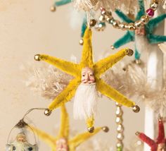 an ornament hanging from a christmas tree decorated with starfishs and ornaments