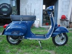 a blue scooter parked in front of a building