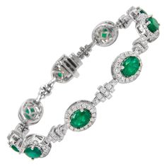 Exquisite and elegant emerald and diamond bracelet. 13.22 carats total gemstone weight. 9 oval cut emeralds, approximately F2, 6.57 carats. Complimented by 224 round brilliant diamonds, 2.51 carats. Approximately G/H color and SI clarity. 18k white gold, 22.12 grams, 7.25 inches. Accommodated with an up to date appraisal by a GIA G.G. upon request. please contact us with any questions. Item Number B3770 Bracelet Emerald, Modern Bracelets, Emerald Jewelry, Emerald Diamond, Oval Cut, Diamond Bracelet, My Jewellery, Bangle Bracelets, Jewelry Box