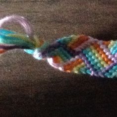 a crocheted object is laying on the floor with it's end twisted up