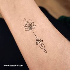 a woman's arm with a tattoo on it that has a flower in the middle