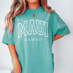 Step into paradise with our "Maui Hawaii Comfort Color Tee," a must-have for island lovers and adventurers alike. As you slip on this lush tee, allow it to whisk you away to the balmy beaches and vibrant scenery that Maui is famous for. This tee is designed with premium Comfort Color fabric, offering a soft and durable feel, perfect for your daily escapades around the Valley Isle. The charming "Maui, Hawaii" design embodies the welcoming spirit of the islands, allowing you to carry a piece of Ha Hawaiian Relaxed Fit T-shirt For Vacation, Tropical Crew Neck T-shirt For Vacation, Maui Sweatshirt, Multicolor Tropical Vacation T-shirt, Hawaiian Tropical Print T-shirt For Beach Season, Aloha Spirit, Maui Hawaii, Comfort Color, Comfort Colors Tee