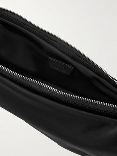 The Row's 'Caiden' messenger bag is sized to fit the daily essentials, like your phone, cardholder and keys. It's been made in Italy from durable shell and has a compact crescent shape. Luxury Travel Mobile Phone Pouch, Modern Pouch With Cell Phone Pocket, Designer Travel Bags With Cell Phone Pocket, Modern Black Pouch With Cell Phone Pocket, Luxury Belt Bag With Zipper Pocket For Travel, Functional Business Belt Bag For Mobile Phone, Luxury Rectangular Belt Bag With Zipper Pocket, Luxury Belt Bag With Cell Phone Pocket For Travel, Summer Sunglasses