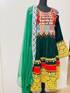 Item#2320 Country of origin: Afghanistan  Price: $200 This Dress comes in two pieces  1: Qamees (Dress) 2: Dupatta (Shawl) We love using vintage handmade embroidery to create that authentic Afghan KUCHI look, especially as each piece is unique. These Afghan clothes are prepared from good quality velvet And different fabric. A lot of beads And Coins are fixed on the dress for Bohemian Green Sets With Embroidered Border, Green Bohemian Set With Embroidered Border, Green Dress With Intricate Embroidery For Navratri, Green Long Sleeve Dress With Traditional Patterns, Green Anarkali Embroidered Dress, Green Anarkali Dress With Traditional Drape, Green Embroidered Dress With Traditional Drape, Green Bohemian Sets With Intricate Embroidery, Green Dresses For Traditional Ceremonies