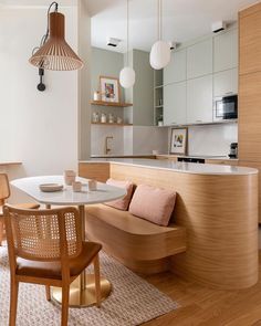 a kitchen and dining area with wooden furniture