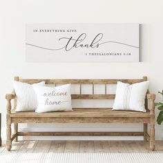 a wooden bench with two pillows on it in front of a wall that says thanks