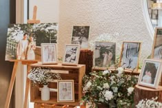 pictures and flowers are on display in front of a window at a wedding reception with easers