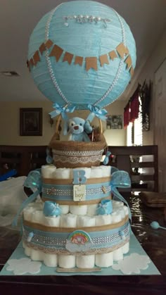 a cake made to look like a hot air balloon with diapers on the bottom