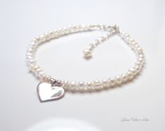 Fall in love all over again with this glimmering silver heart and pearl bracelet....................... White/ Ivory freshwater pearls are AA quality and measure about 2mm Shiny sterling heart measures about 13mm Chain is dainty 925 sterling silver Bracelet is adjustable (choose your size) Bracelet closes with a sterling silver spring clasp This is a handmade item and made for you after the order is placed PACKAGINGAll Jewelry is carefully packaged for a safe arrival and is secured in a jewelry Heart-shaped Pearl Bracelet For Wedding, Elegant White Pearl Bracelet With Heart Charm, Heart-shaped Pearl Charm Bracelet For Wedding, Heart-shaped Pearl Bracelet With Charm For Wedding, Pearl Heart Bracelet For Wedding, Elegant Pearl Bracelet With Heart Beads For Wedding, Wedding Pearl Heart Bracelet, Wedding Heart-shaped Pearl Bracelet, Adjustable Silver Pearl Bracelet For Valentine's Day