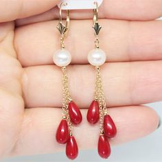 These stunning earrings are made with 14k solid yellow gold, natural freshwater round Pearl and red Coral teardrop stones.  Metal: 14k solid yellow gold Stone: Natural freshwater Pearl (7mm approx.), red Coral (9X5mm approx.)  Chain type: Cable Closure: Lever backs Fleur-De-Lis  Golden balls: 10pc. -  2mm approx.  Total length: 2 1/2 inches approx. Total weight: 4 g. approx. IMPORTANT NOTE: These pictures are maximum zoomed in, so the actual size of the jewelry is noted in the description. We st Formal Red Hypoallergenic Jewelry, Red Hypoallergenic Jewelry For Formal Occasions, Hypoallergenic Red Jewelry For Formal Occasions, Red Pearl Drop Jewelry For Anniversary, Red Hypoallergenic Drop Jewelry, Hypoallergenic Red Drop Jewelry, Red Pearl Drop Round Earrings, Red Round Pearl Drop Earrings, 14k Gold Red Earrings For Pierced Ears