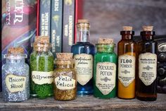 several bottles with different types of spices in them on a shelf next to some books