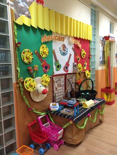 the children's play area is decorated in bright colors and has toys on display