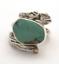 Sterling silver twig style ring with bronze accent and bezel set turquoise approximate width 3/4 of an inch.Note: turquoise may vary slightly Artisan Oval Jewelry With Bezel Setting, Turquoise Bohemian Rings With Gemstone Accents, Bohemian Turquoise Rings With Gemstone Accents, Fine Jewelry Turquoise Bezel Setting, One Of A Kind Elegant Turquoise Jewelry, Elegant One-of-a-kind Turquoise Jewelry, Artisan Turquoise Ring Jewelry, Turquoise Jewelry With Stone Setting For Anniversary, One Of A Kind Turquoise Jewelry For Anniversary