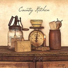 an old time kitchen scene is displayed in a black frame on a wooden table with the words country kitchen written above it