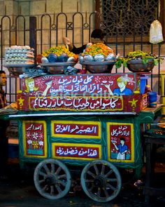 a cart with food on it in front of a building