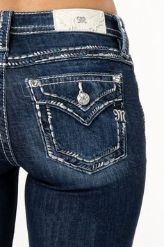 Mid-rise, dark-wash bootcut jeans- Silver, grey, black and blue saddle-stitched border design- Faux flap pocket with rhinestone rivets- Embossed white leather wing Miss Me brand patch- Slight fading with whiskering- 5-pocket designModel is wearing size: 25Model Measurements:Height: 5'9"Bust: 32"Waist: 26"Hips: 35"Fabric Content: 99% Cotton, 1% ElastaneCare: Gentle machine wash inside-out with like colors in cold water. Tumble dry low.Style No. M5014B406L-D1110, M5014B406V-D1110, M5014B406S-D1110 Cute Jeans Pockets, Bootcut Jeans Aesthetic, Y2k Mid-rise Jeans With Pockets, Miss Me Jeans Outfit, Miss Me Jean Shorts, Bootcut Jeans With Pocket Design, Bootcut Jeans For Women, Bke Jeans Womens Bootcut, Miss Me Flare Jeans