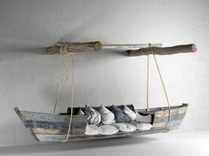 a wooden boat with pillows hanging from it's sides