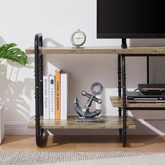 a shelf with books, an anchor and a clock on it in front of a white wall