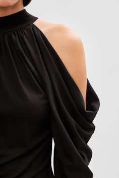 Our Perry Cold Shoulder Top is all about the drape. Crafted in soft Tencel jersey, from a halter collar neckline, long, cold shoulder raglan sleeves create beautiful drapes that cascade down the arms. Perry's a statement top that delivers all the style required for a head-turning look. | Sam is 5'8" (173 cm) tall, wearing size XS. Total length from the center back is approximately 22.5" (57cm). Sleeve length is approximately 25.5" (65 cm).Sustainable European Jersey (96% Tencel, 4% Elastane).Mac Luxury Black One-shoulder Top For Women, Elegant Black One-shoulder Top With Asymmetrical Hem, Versatile Black One-shoulder Top With Asymmetrical Neckline, Black Stretch Off-shoulder Top In Elastane, Black Stretch One-shoulder Top With Asymmetrical Neckline, Sweatshirt Fabric, Cold Shoulder Top, Loose Fitting Tops, Fashion Updates